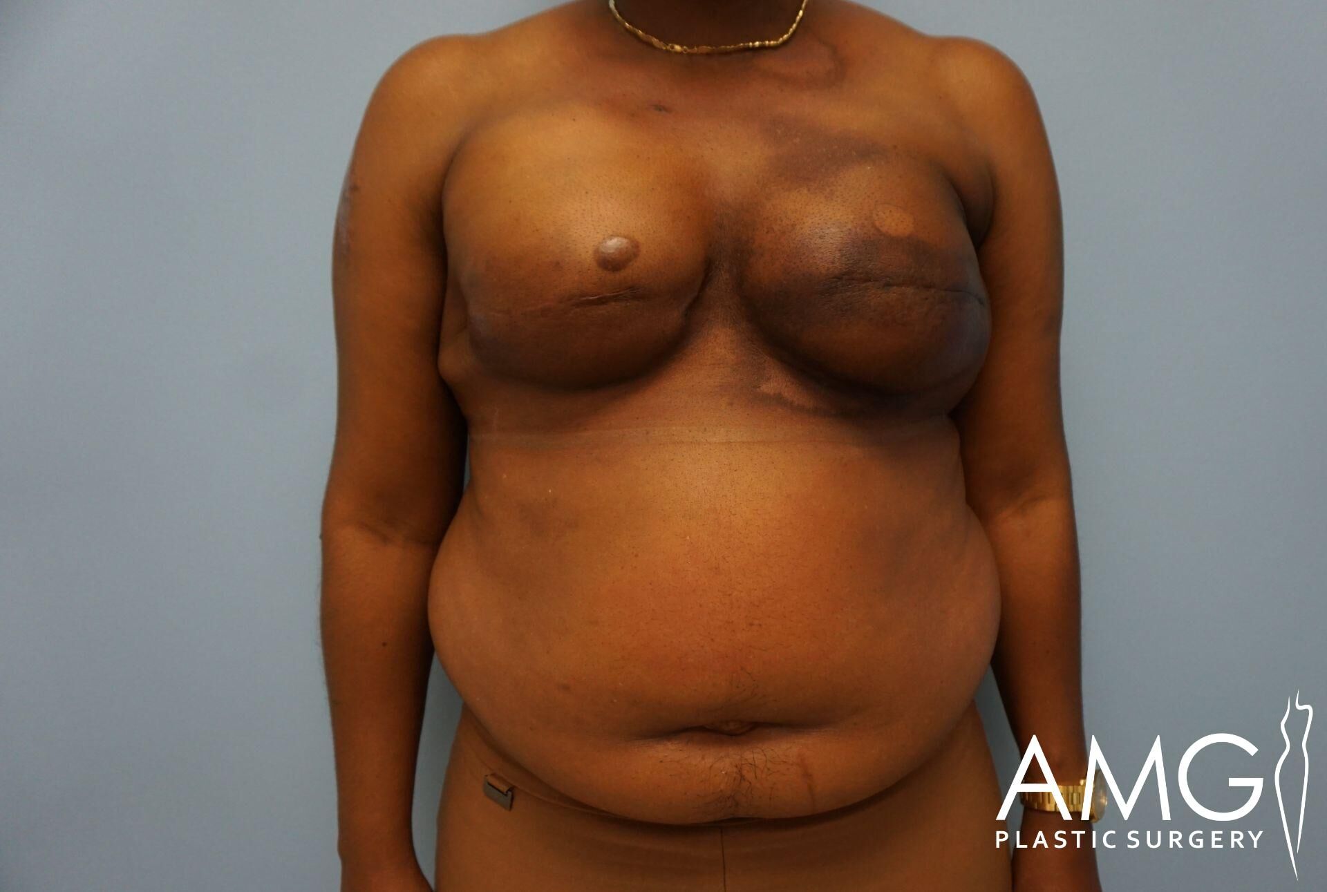 A person with a bare chest is standing against a blue background. The image has text in the corner: 
