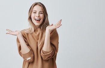 beautiful woman with blonde long hair looking at camera having excited and happy facial expression
