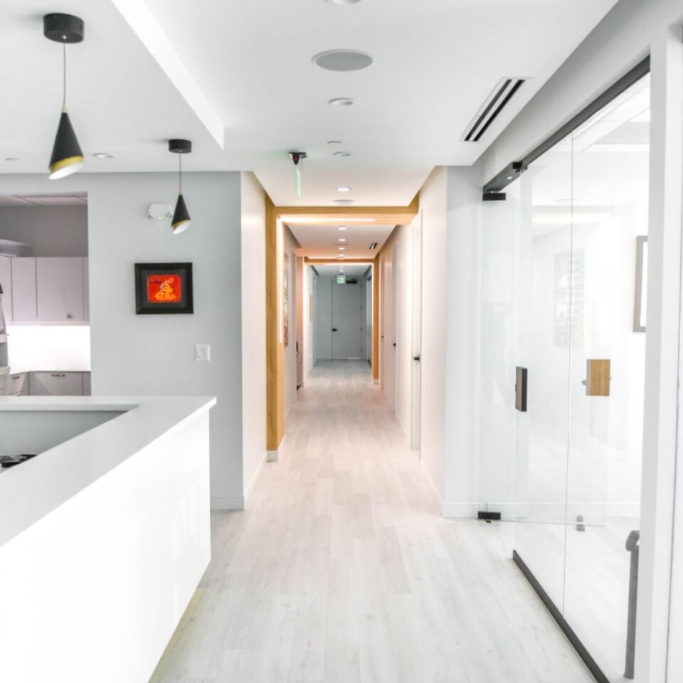 Bright hallway in the clinic with a white reception counter