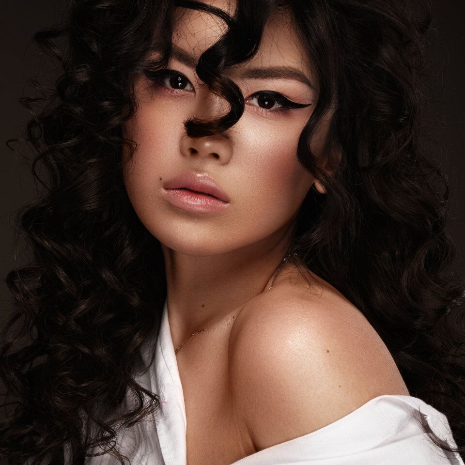 Portrait of a woman with long dark curly hair